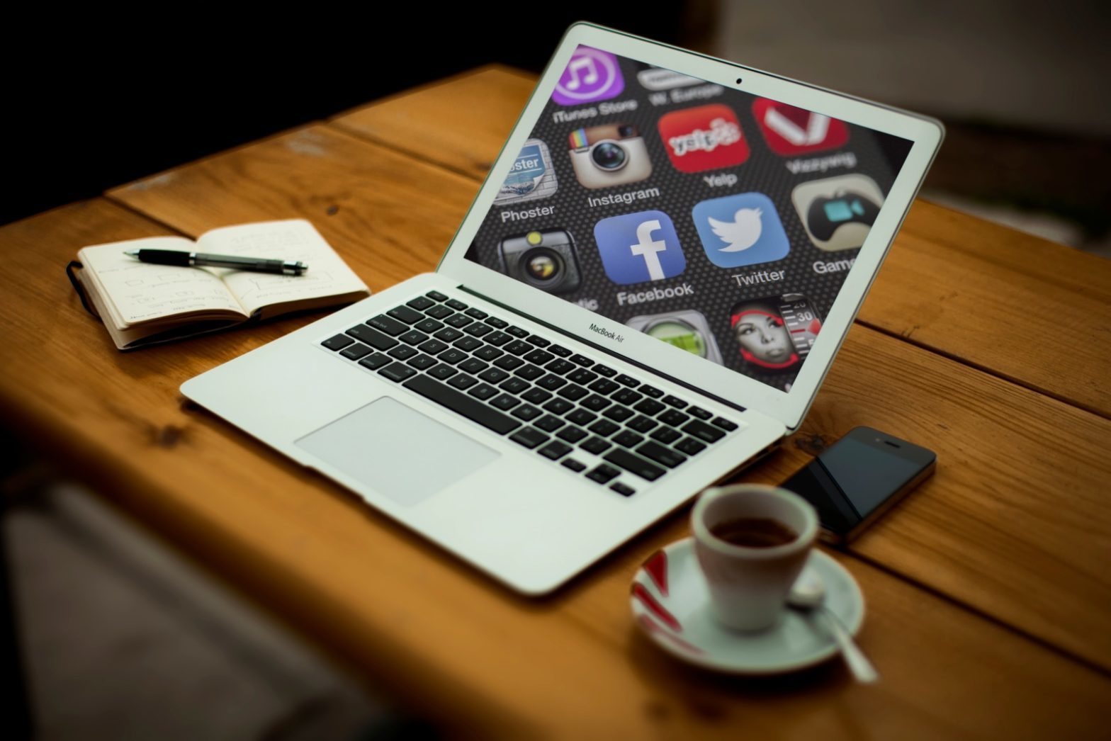 Social media platform icons shown on a laptop screen